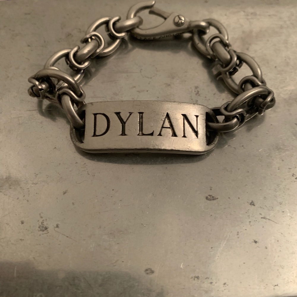 Never worn silver color bracelet with the name inscribed Dylan.